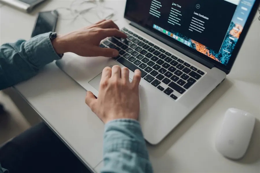 Hands working on a laptop
